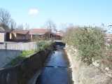 [Salmon's Brook as it approaches the culvert under The Green (31/3/2004).]