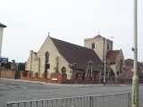 [St Edmund's church sits on the junction of the Hertford Road with Croyland Road (27/04/2004).]