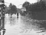 [The Hertford Road under floodwater in July 1956 by St&nbsp;Edmunds School.]
